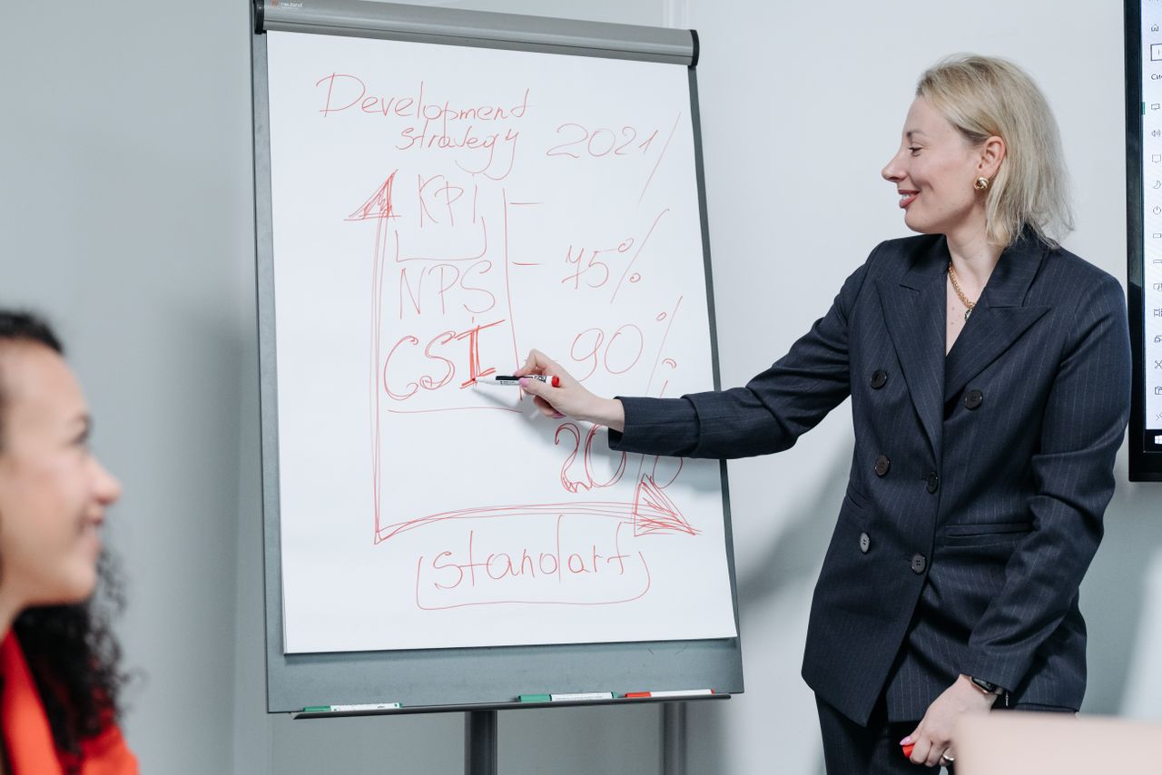 Professional woman delivering a business presentation on market strategy metrics indoors.